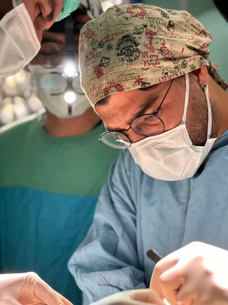 Op. Dr. Harun Tekin concentrating during a surgical operation in the operating room
